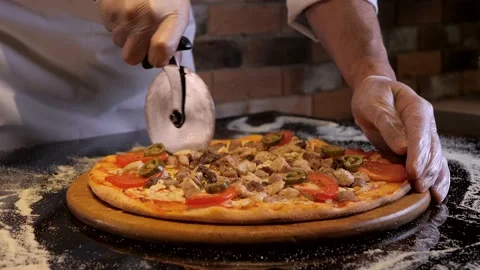 Chef cuts pizza with round knife. Italian cuisine, appetizing fast food. Stock Footage 132004759