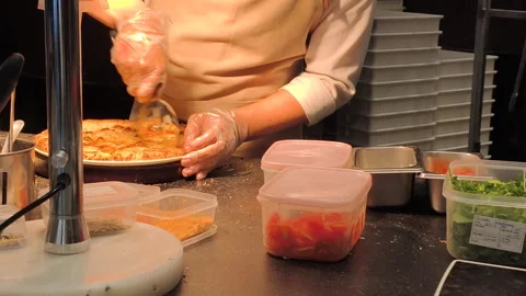 The chef cuts the pizza into slices with a special knife. Stock Footage 319536721