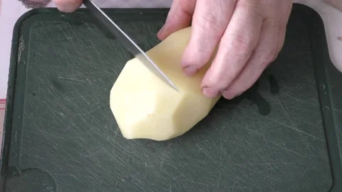 Chef cuts potatoes with a knife Stock Footage 171280480