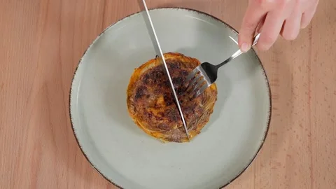 The chef cuts the prepared dish with cutlet and cabbage Stock Footage 265177058