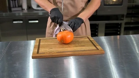 The chef cuts a pumpkin Stock Footage 97880842