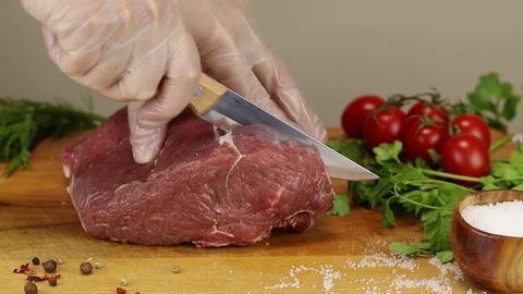 Chef cuts raw beef meat Stock Footage 122205458