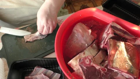 Chef cuts raw deer meat with a knife Stock Footage 165315066