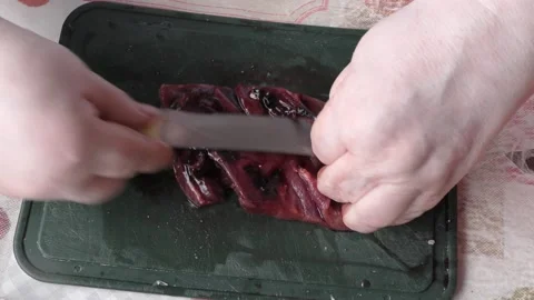 Chef cuts raw deer meat with a knife Stock Footage 167105960