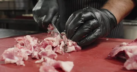 Chef cuts raw meat with fat. Knife cutting of meat. Close-up Stock Footage 260655886