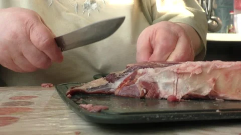 The chef cuts raw meat Stock Footage 165040076