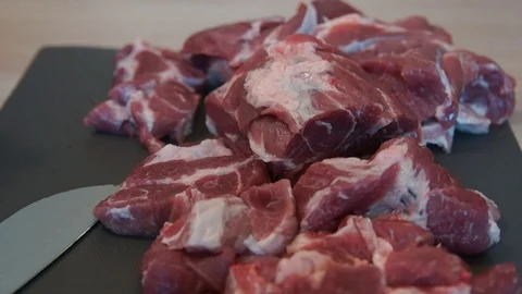 The chef cuts raw meat with the knife. Chef cutting pork meat. Cutting meat Stock Footage 99392990