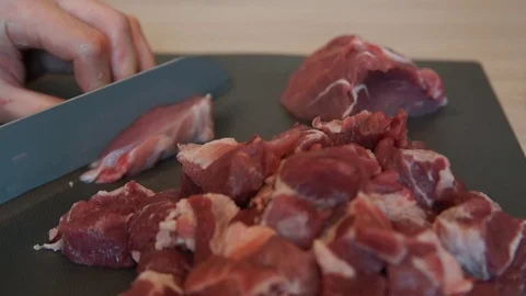 The chef cuts raw meat with the knife. Chef cutting pork meat. Cutting meat Stock Footage 99393375