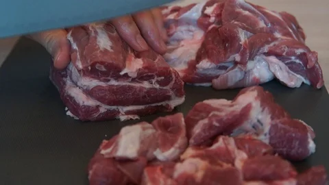 The chef cuts raw meat with the knife. Chef cutting pork meat. Cutting meat Stock Footage 99742731