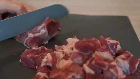 The chef cuts raw meat with the knife. Chef cutting pork meat. Cutting meat Stock Footage 99742897