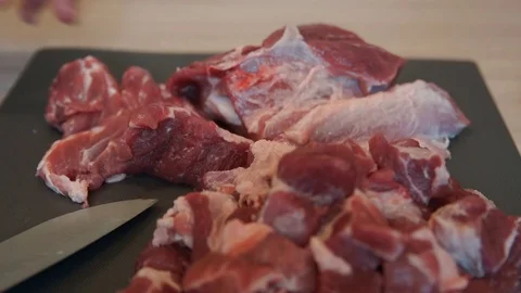 The chef cuts raw meat with the knife. Chef cutting pork meat. Cutting meat Stock Footage 99881693