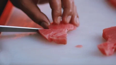 Chef cuts raw meat with the knife in kitchen cooking beefsteak preparation Stock Footage 100302946