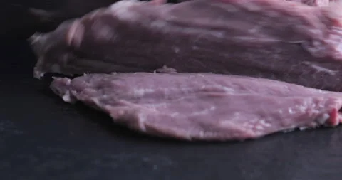 The chef cuts raw meat with the knife Stock Footage 125607650