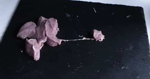 The chef cuts raw meat with the knife Stock Footage 125608496