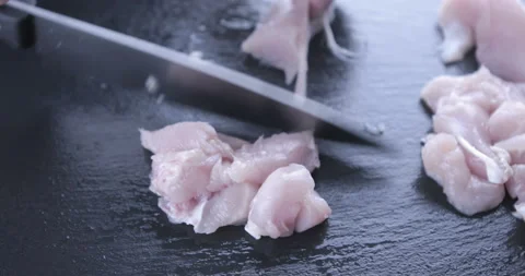 The chef cuts raw meat with the knife Stock Footage 125611044