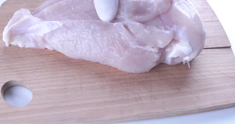 The chef cuts raw meat with the knife Stock Footage 125611833