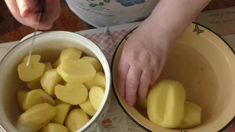 Chef cuts raw potato with a knife Stock Footage 165315076