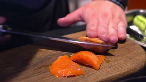 The chef cuts red fish, a delicacy, with a knife. Red fish salad. Close ap. Stock Footage 171682169
