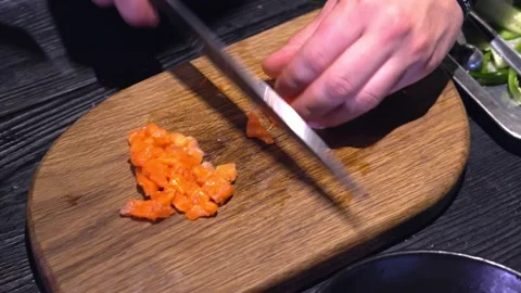 The chef cuts red fish, a delicacy, with a knife. Red fish salad. Close ap. Stock Footage 171682259