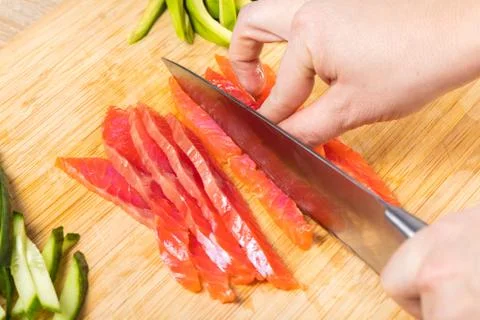 The chef cuts red fish with a knife Stock Photos