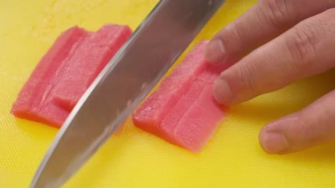 The chef cuts the red fish into slices on a board Stock Footage 212418103
