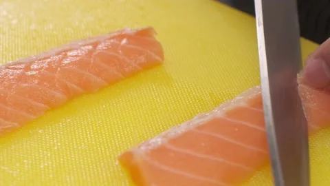 The chef cuts the red fish into slices on a board Stock Footage 231016054