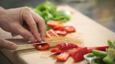 Chef cuts red green pepper on cutting board in industrial kitchen Stock Footage 71518975