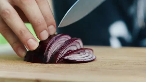 Chef cuts red onion close up of hand and knife full HD video Stock Footage 130769675