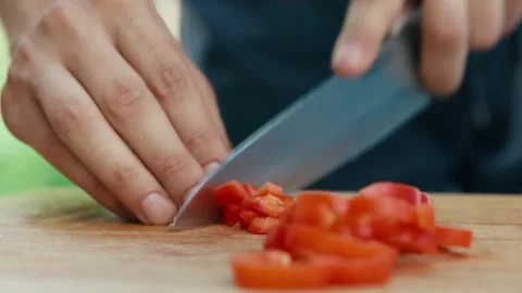 Chef cuts red pepper on a Board close up of hands and knife full HD video Stock Footage 130790067