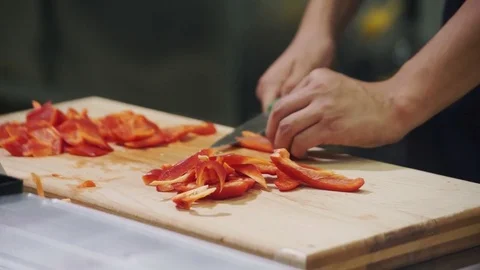 Chef cuts red pepper on cutting board in industrial kitchen Stock Footage 71519439