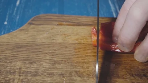 Chef cuts the red pepper in small pieces Stock Footage 73816300