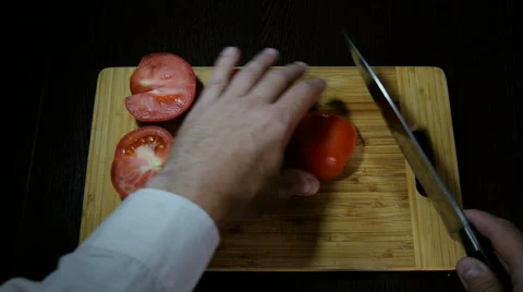 Chef cuts red tomatoes for salad Video stock 66200696