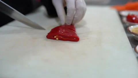 Chef Cuts Roasted Red Peppers On A Wooden Cutting Board, Slow Motion. Video stock 196160413