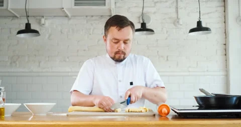 Chef cuts rolled dough to make homemade pasta. Cooking italian food Video stock 133243282