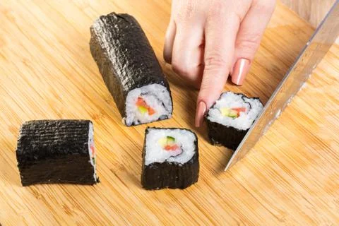 Chef cuts rolls, hands close-up Stock Photos