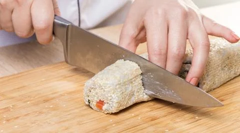 Chef cuts rolls, hands close-up Stock Photos
