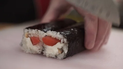 Chef cuts the rolls on the table with a knife Stock Footage 106670228