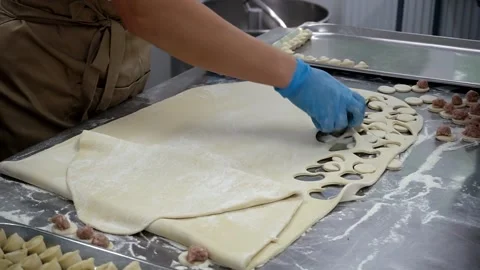 The chef cuts round dough pieces for making dumplings. Stock Footage 247733888