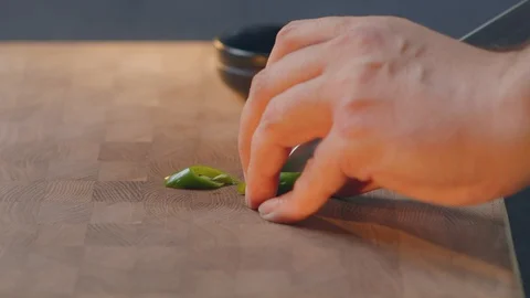 Chef cuts salad dressing hot green pepper male hands hold a sharp knife and cut Stock Footage 129608937