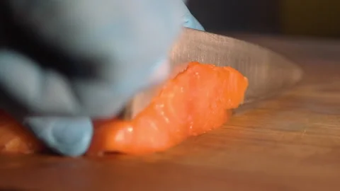 Chef cuts salmon for cooking Stock Footage 158021793
