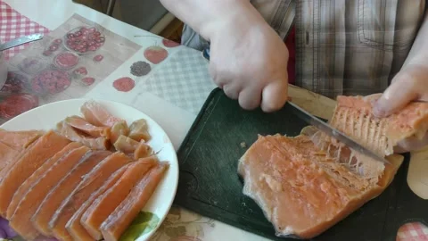 Chef cuts salmon fish with a knife Stock Footage 187642284