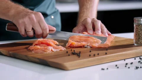 Chef cuts the salmon slow motion Video stock 220665307