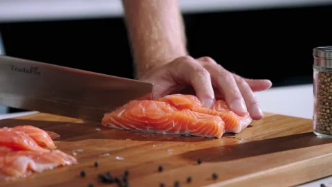 Chef cuts the salmon slow motion Stock Footage 237886702