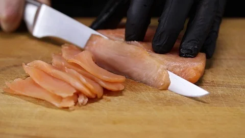 Chef cuts salmon into thin slices Stock Footage 122995181