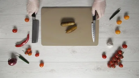 Chef cuts satled cucumbers or pickled cucumber on plastic board top view Stock Footage 128313047