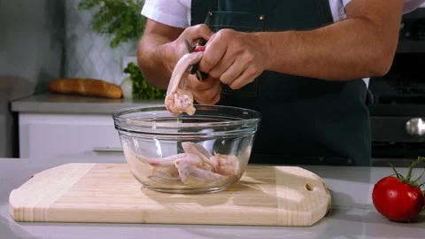 Chef cuts by scissors chicken wings Stock Footage 236206803