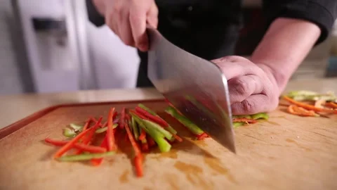 Chef cuts shredded green and red pepper (1) Stock Footage 202166660