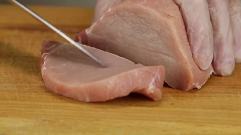 Chef cuts a slice of raw pork carbonate Stock Footage 122107005