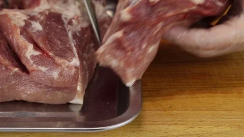 Chef cuts a small piece of meat Stock Footage 122133673