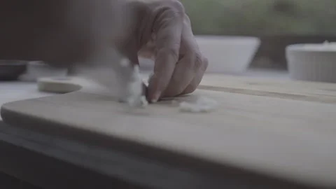 The Chef Cuts Into Small Pieces Fresh White Onions On A Wooden Cutting Board Stock Footage 266797527